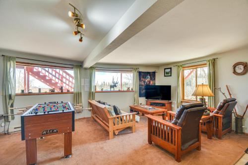 a living room filled with furniture and a table at Fairplay Cabin with Mtn View about 4 Mi to Platte River! in Fairplay
