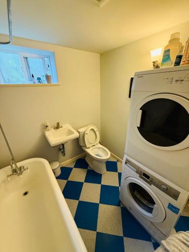 a bathroom with a sink and a toilet and a microwave at Southeast Portland Parkside Gem on Mount Tabor in Portland