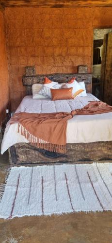 a bedroom with a large bed with pillows at Chale do guerreiro in Coroas
