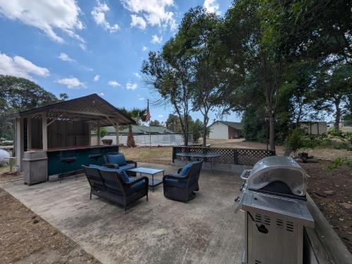 a backyard with a pool table and chairs and a grill at Squaw Valley Motel Room #1 in Squaw Valley