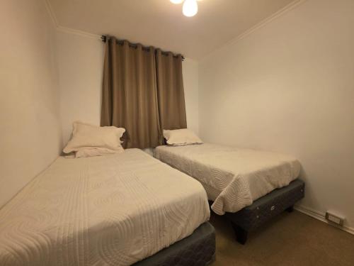 a bedroom with two beds and a window at Don Alfonso Los Andes in El Cerrillo