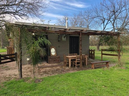 a small house with a table and chairs and a table and bench at Los Rosales - Genuinamente Campo in Torres