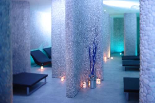 a lobby with two vases with flowers and candles at Hotel Neptun - Terme & Wellness Lifeclass in Portorož