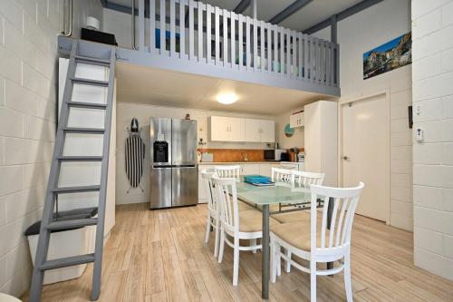a kitchen with a table and chairs and a loft bed at Beachfront 1BR and Loft Bliss Surf Cafe Escape in Marcoola