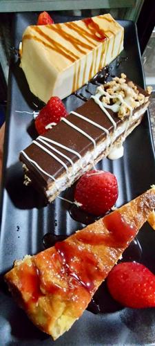 a tray of desserts with chocolate and strawberries on it at Ignis Rural Apartment - Casillas Valle de Ayora in Jalance