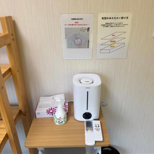 a coffee maker on a table in a room at Stay&Work HIRAJO in Yokote