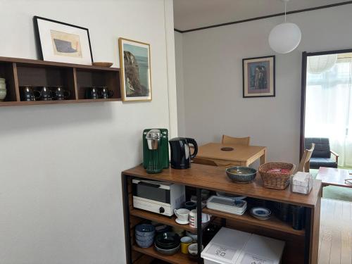 a kitchen with a table with a microwave on it at A cozy home between Osaka and Kyoto -UNiCO- in Takatuki