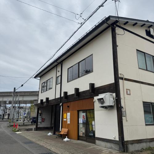 a building on the side of a street at Stay&Work HIRAJO in Yokote