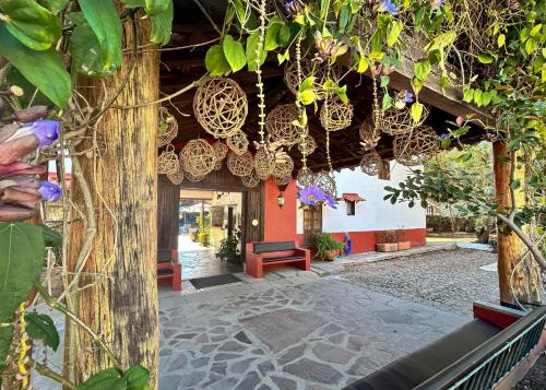 a building with a bunch of hanging baskets at El Mesón del Ticúz Tapalpa in Tapalpa