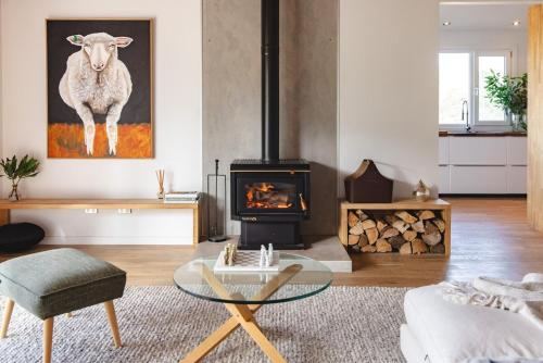 a living room with a glass table and a fireplace at Navigators Rest in Gordon