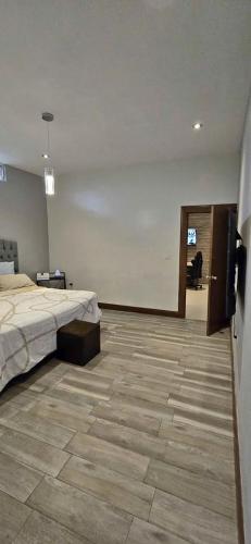 a bedroom with a bed and a television in it at Loft Mi Alegria in El Jobo