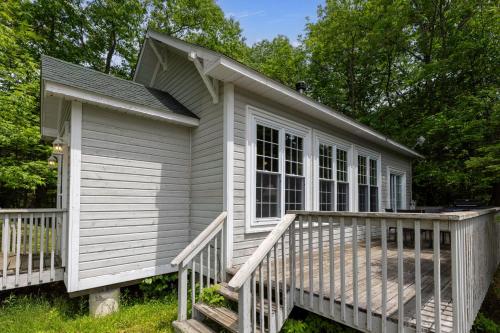 a small house with a porch and a deck at Port Cunnington Lodge in Dwight