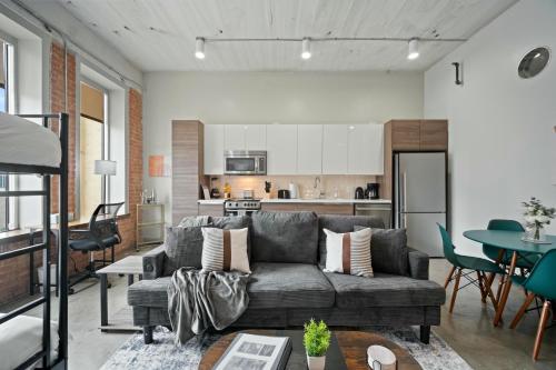 a living room with a couch and a table at Stunning Downtown Apartment with Pool, Laundry, Parking in Dallas