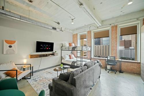 a living room with two couches and a tv at Stunning Downtown Apartment with Pool, Laundry, Parking in Dallas