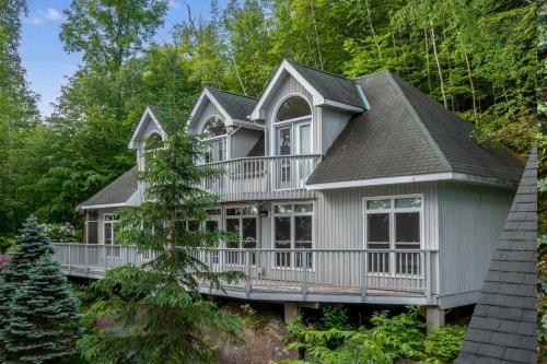 a large house with a wrap around porch at Port Cunnington Lodge in Dwight