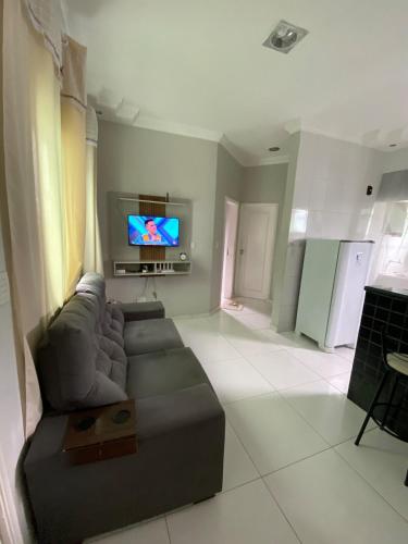 a living room with a couch and a flat screen tv at Alugo apartamento COP 30 in Ananindeua