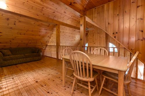 a dining room with a table and chairs in a cabin at Port Cunnington Lodge in Dwight