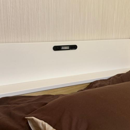 a remote control on top of a white wall at Stay&Work HIRAJO in Yokote