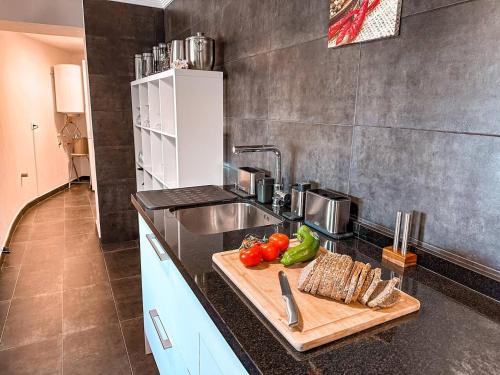 a kitchen with a cutting board with vegetables on a counter at Bona Vista Villa Calpe in Calpe