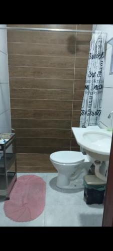 a bathroom with a toilet and a sink at Chales do Lobão in São Sebastião