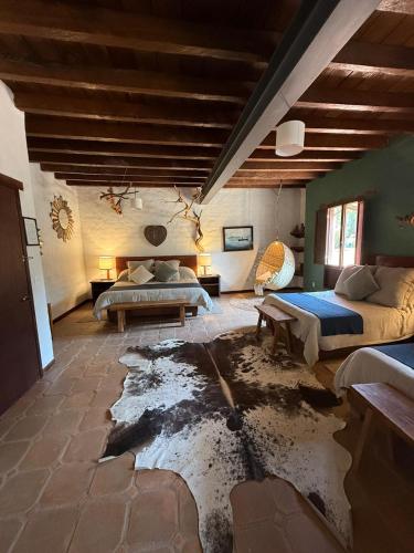 a room with two beds and a damaged floor at El Mesón del Ticúz Tapalpa in Tapalpa