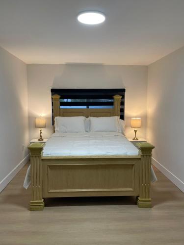 a bedroom with a large bed with two lamps at Miami Freedom Park Oasis by H&S in Miami