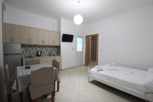 a kitchen with a bed and a table in a room at Central Villa Shameti in Ksamil