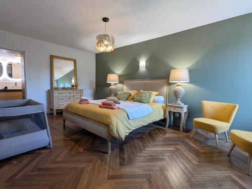 a bedroom with a large bed and a mirror at Maison avec piscine privative et jacuzzi à Rouvres-les-Bois - FR-1-591-722 in Rouvres-les-Bois