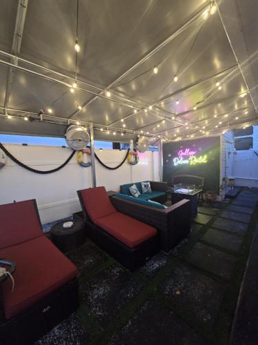 a living room with a couch and chairs in a tent at Gallego Deluxe Rental in Key Largo