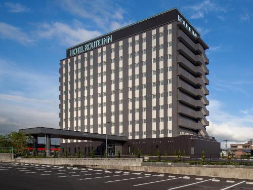 a hotel building with a sign on the side of it at Hotel Route Inn Shunan - Tokuyama Higashi Inter - in Shunan