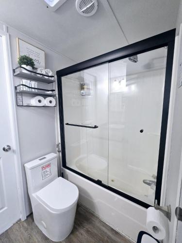 a bathroom with a toilet and a glass shower at Gallego Deluxe Rental in Key Largo