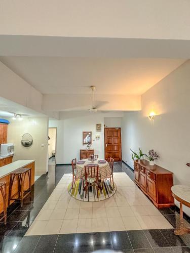a kitchen and dining room with a table and chairs at Regency Tanjung Tuan - Idealhub in Port Dickson