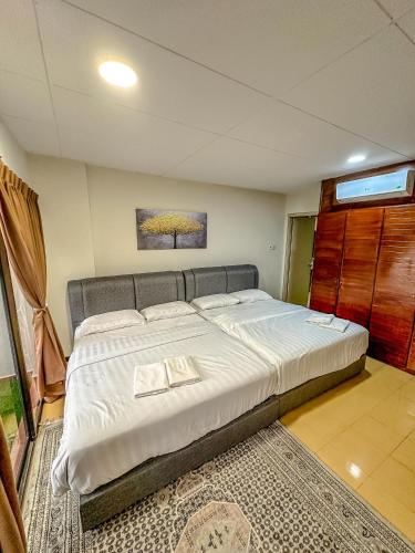 a bedroom with a large bed in a room at Regency Tanjung Tuan - Idealhub in Port Dickson