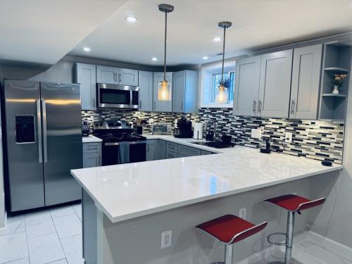 a kitchen with a white counter top and a refrigerator at North Bethesda Gem - Entire House 5 min from Metro in Rockville
