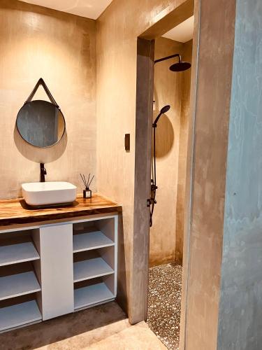 a bathroom with a sink and a shower at Beach People Hostel Bantayan Island in Ocoy
