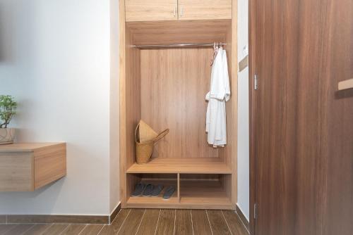 a walk in shower with a wooden cabinet in a bathroom at Bamboo Riverside Boutique Hotel in Ben Tre