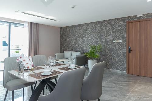 a dining room with a table and chairs at Bamboo Riverside Boutique Hotel in Ben Tre