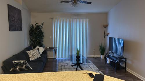 a living room with a couch and a tv at VerPaX Lux Private Room in Indianapolis