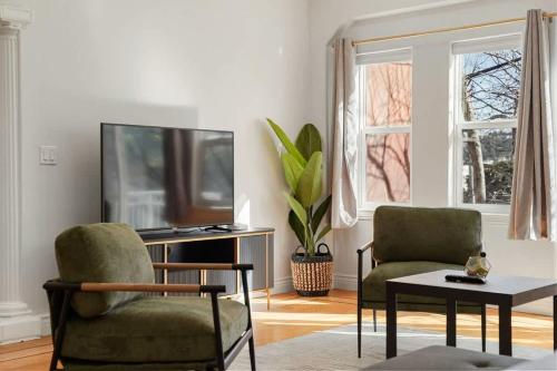 a living room with two chairs and a tv at Spacious 3BR, One and a half Bath 2nd Floor in San Francisco in San Francisco
