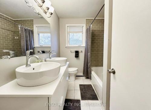 a white bathroom with a sink and a toilet at Markham Peaceful Room-Free Wifi&Parking in Markham