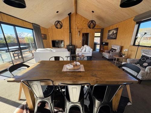 a dining room with a large wooden table and chairs at Wayfarers Lodge in Lake Tekapo