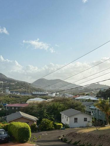 a view of a town with houses and mountains at Peaceful 2BR home, perfect for a Caribbean getaway in Gros Islet