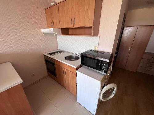 a small kitchen with a sink and a microwave at Julia Vigo Panorama apartments in Nesebar