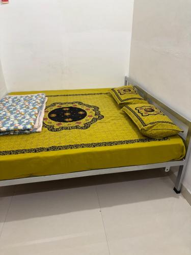 a bed with two pillows on top of it at Shivaksh Rental Flats and Rooms- Best Hotel in Bhawani Mandi in Bhawāni Mandi