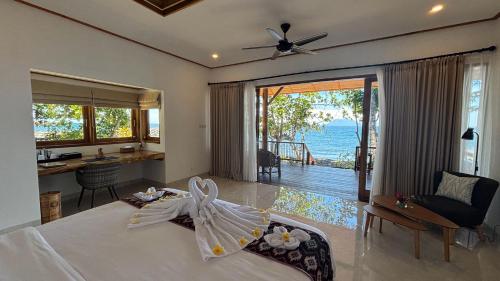 a bedroom with a bed and a view of the ocean at Murex Dive Resort in Manado
