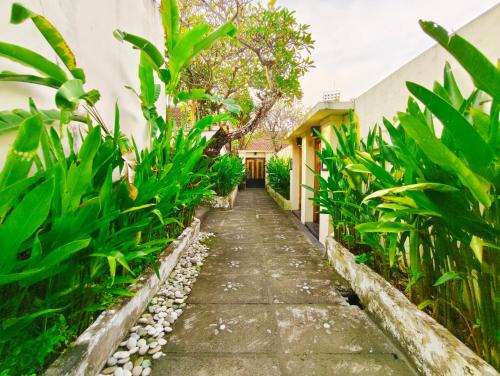 a path through the garden of a house at Private Pool Villas Kuta Bali in Kuta