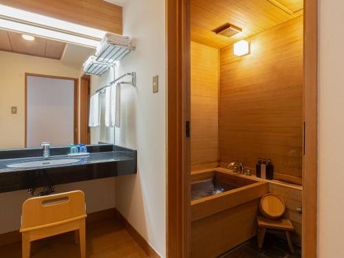 a bathroom with a sink and a mirror at Hotel Atollemerald Miyakojima in Miyako Island