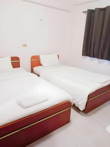 Postel nebo postele na pokoji v ubytování X GO INN Maya - Nimman Chiang Mai เมญ่า