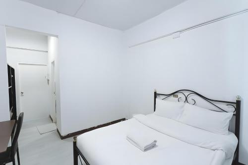 Postel nebo postele na pokoji v ubytování X GO INN Maya - Nimman Chiang Mai เมญ่า