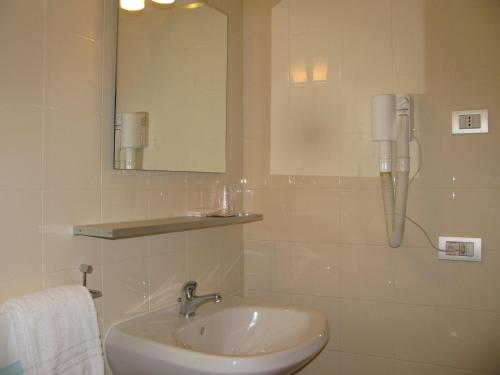 a bathroom with a sink and a phone on the wall at Lieta Sosta in Colfiorito